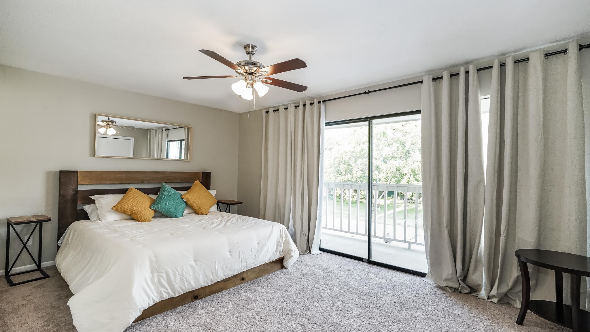 129 Capetown Conroe, TX 77356 - Photo 10 of 35 a bedroom with a large bed and a chandelier