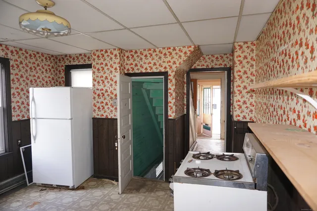 a kitchen with a refrigerator and a stove