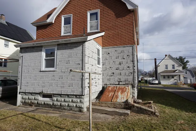 a view of a brick house with many windows