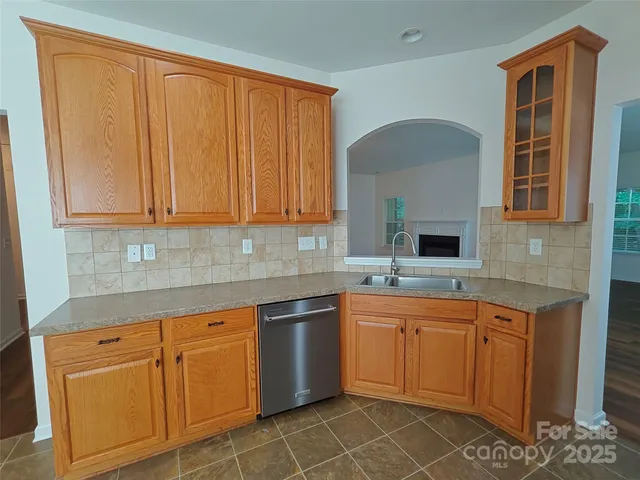 a kitchen with cabinets a sink and appliances