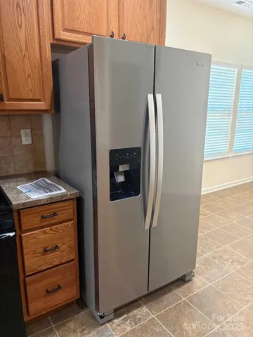 a view of a refrigerator in kitchen