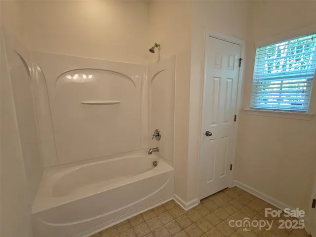 a bathroom with a bathtub and shower