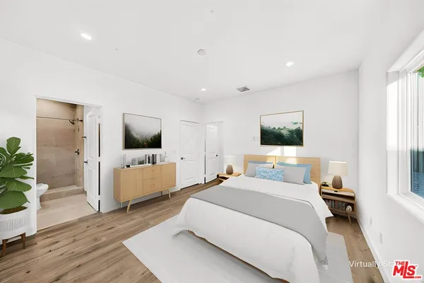 a bedroom with a bed and a flat screen tv