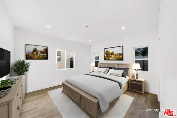 a room with a bed and a flat screen tv