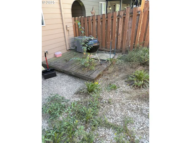 a view of a backyard with table and chairs