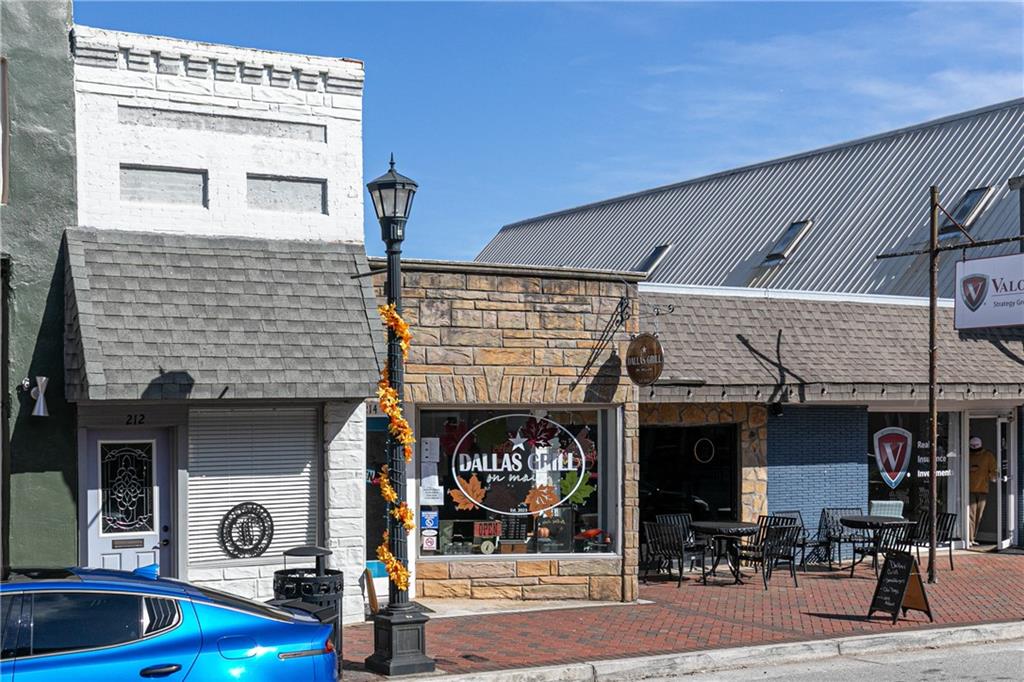 0 East Foster Avenue Dallas, GA 30132 - Photo 28 of 48 a front view of a building with retail shops