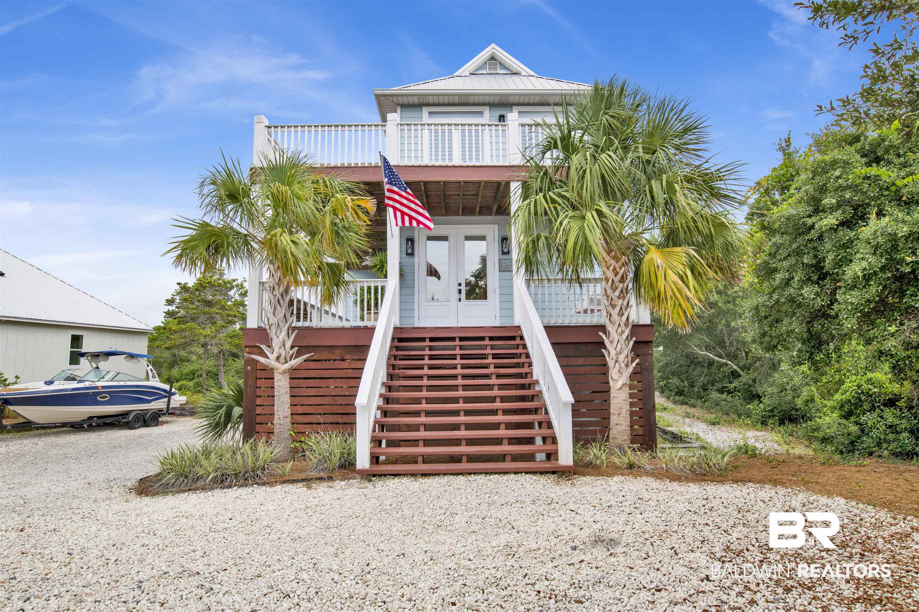 30351 River Road Orange Beach, AL 36561 - Photo 38 of 44 Coastal-style elevated home with a light blue exterior and white trim