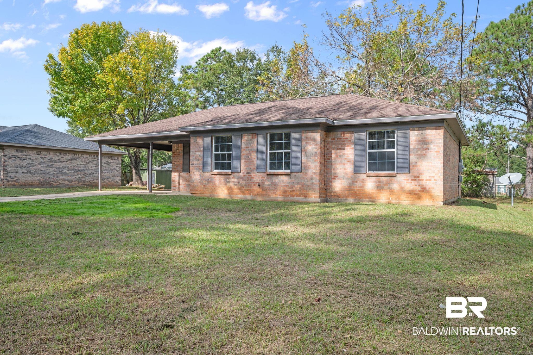 811 East Verbena Avenue Foley, AL 36535 - Photo 7 of 16 View of front of home featuring a front lawn and a carport