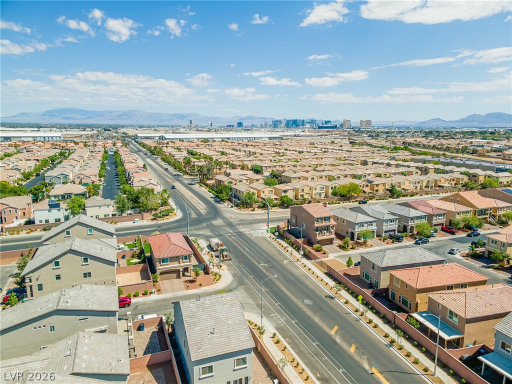 5510 Ripple Ridge Avenue Las Vegas, NV 89139 - Photo 12 of 45 This elevated view captures a sprawling suburban landscape under a vast sky.
