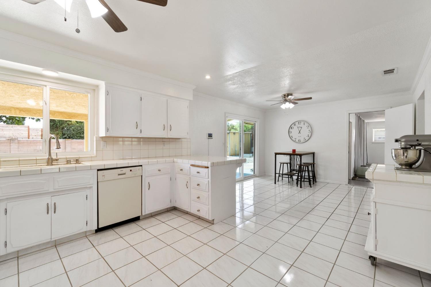 36264 Ave 12 Madera, CA 93636 - Photo 11 of 23 a kitchen with white cabinets and sink