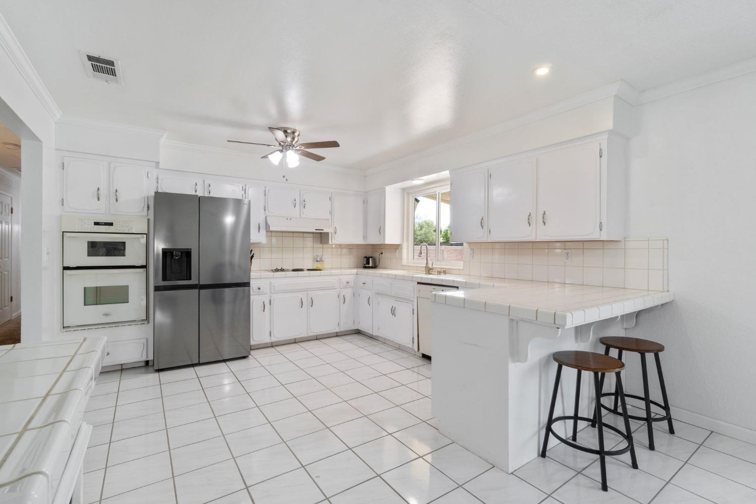 36264 Ave 12 Madera, CA 93636 - Photo 12 of 23 a kitchen with a sink cabinets and stainless steel appliances