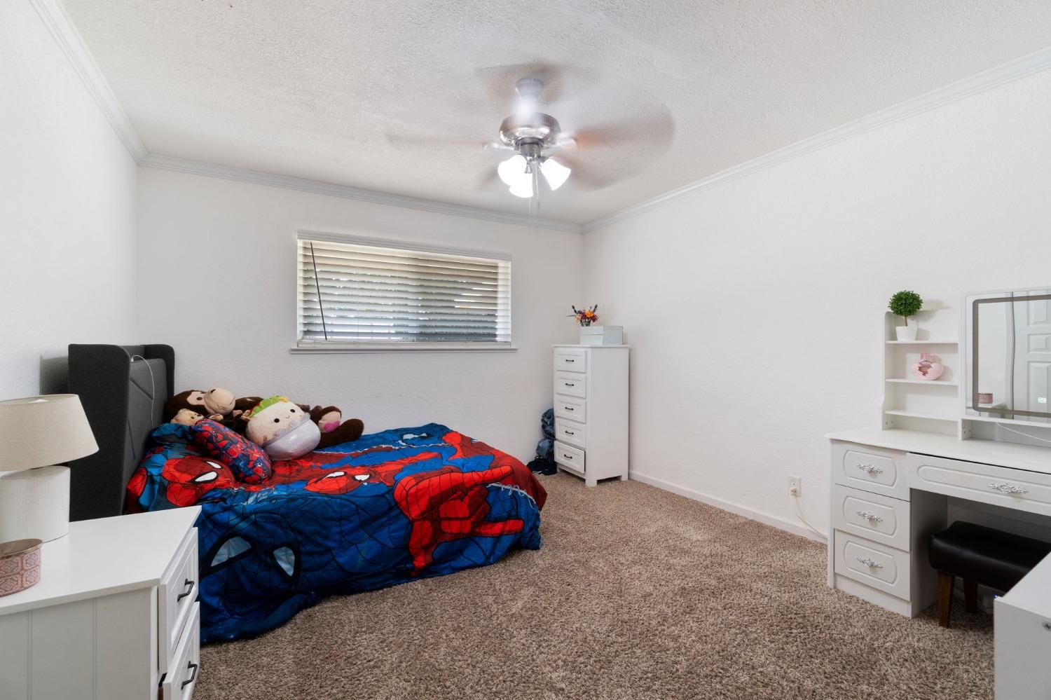 36264 Ave 12 Madera, CA 93636 - Photo 19 of 23 a bedroom with a bed and a chandelier