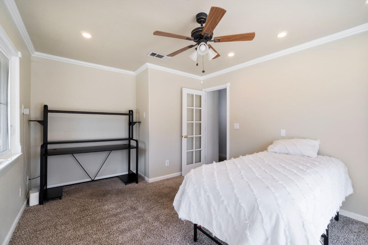 36264 Ave 12 Madera, CA 93636 - Photo 21 of 23 a bedroom with a bed and a chandelier