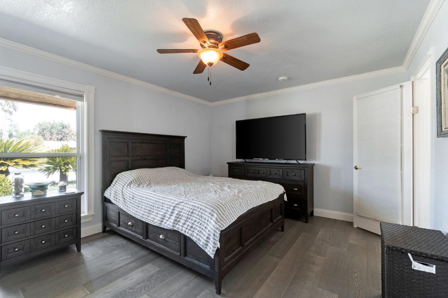 36264 Ave 12 Madera, CA 93636 - Photo 22 of 23 a bedroom with a bed and a flat screen tv