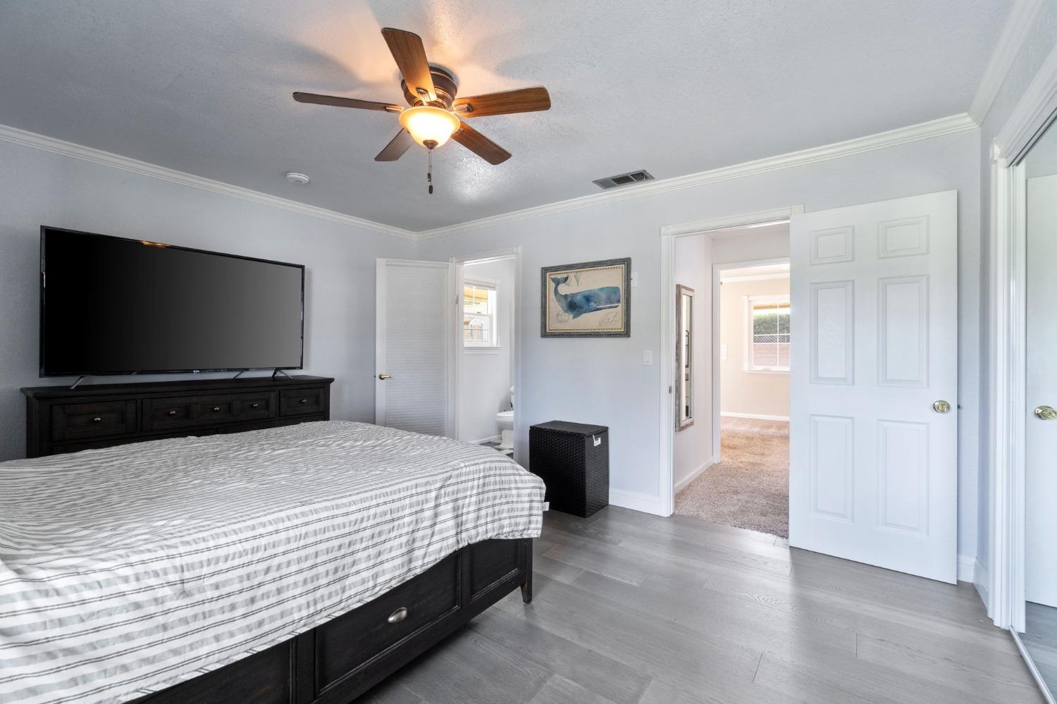 36264 Ave 12 Madera, CA 93636 - Photo 23 of 23 a bedroom with a bed and a flat screen tv