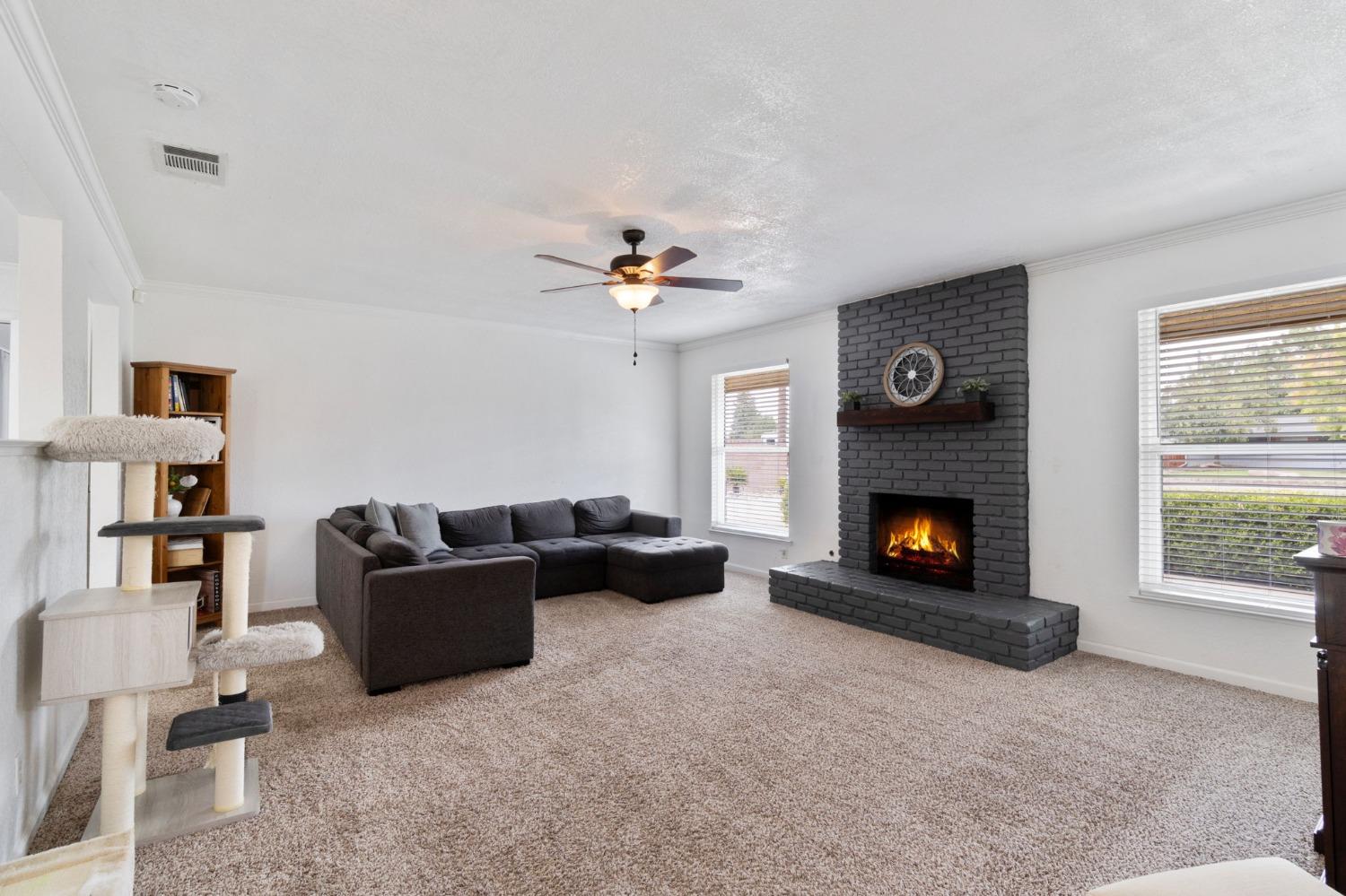 36264 Ave 12 Madera, CA 93636 - Photo 6 of 23 a living room with furniture and a fireplace
