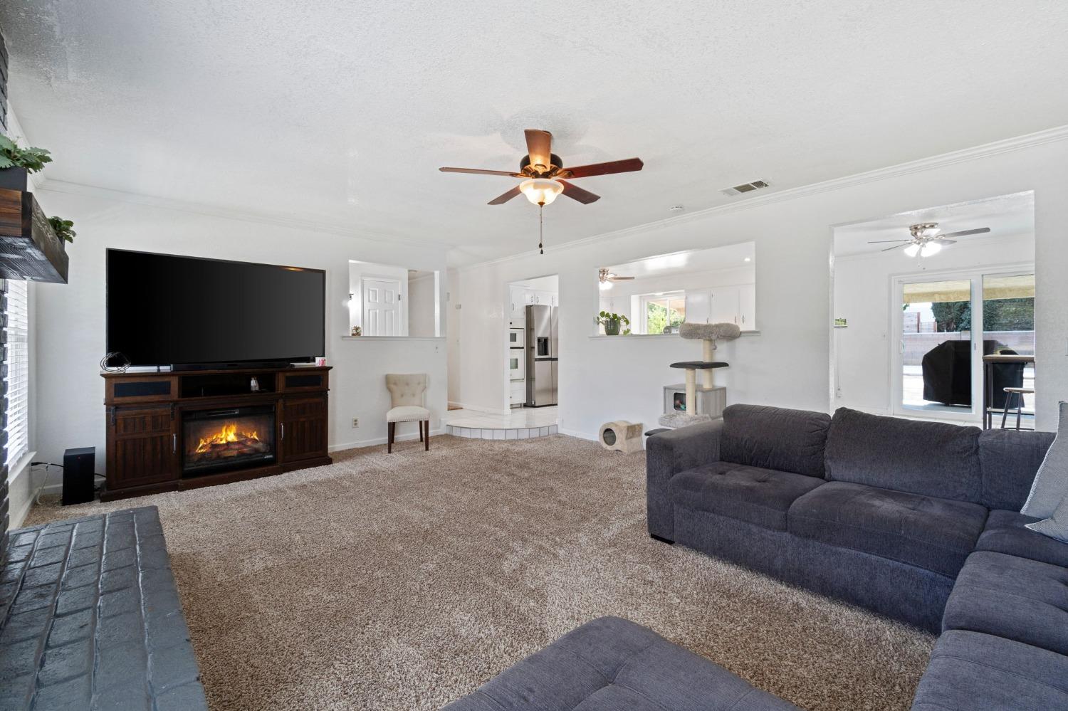 36264 Ave 12 Madera, CA 93636 - Photo 8 of 23 a living room with furniture and a flat screen tv