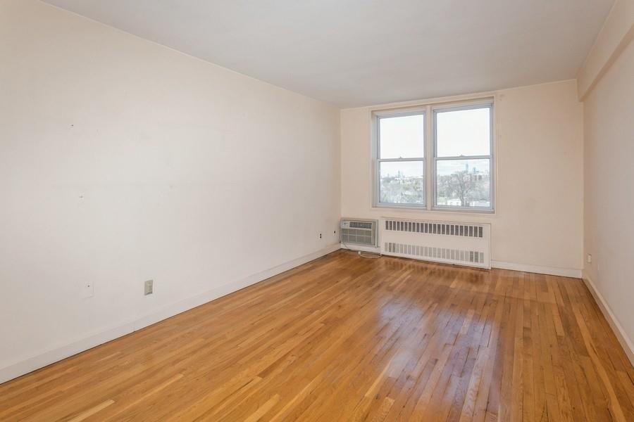 8301 Ridge Boulevard, Unit 6F Brooklyn, NY 11209 - Photo 14 of 24 an empty room with wooden floor and windows
