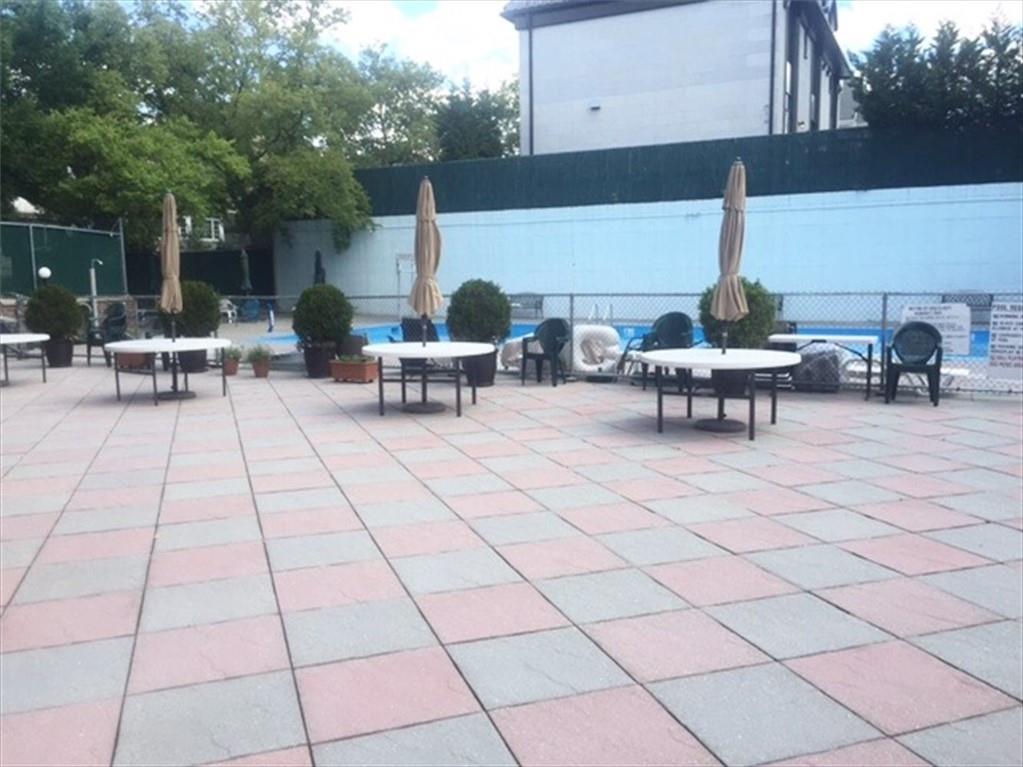 8301 Ridge Boulevard, Unit 6F Brooklyn, NY 11209 - Photo 23 of 24 a view of a patio with dining table and chairs with a fire pit and a barbeque grill