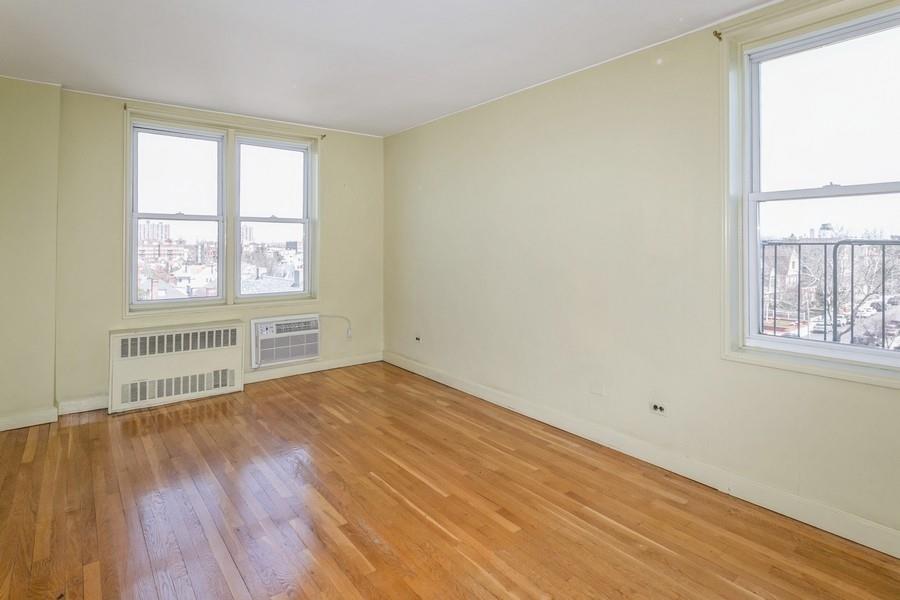 8301 Ridge Boulevard, Unit 6F Brooklyn, NY 11209 - Photo 10 of 24 a view of an empty room with wooden floor and a window