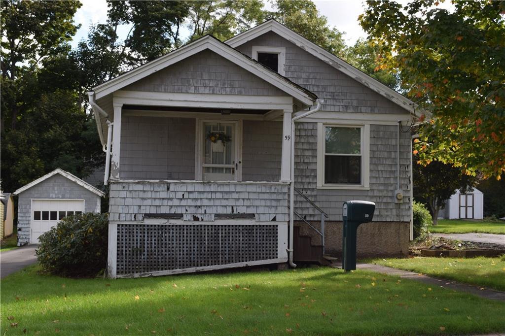 59 Clinton Street Meriden, CT 06450 - Photo 1 of 1 a front view of a house with a yard and garage