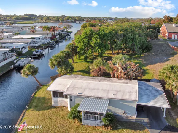 an aerial view of a house with a yard