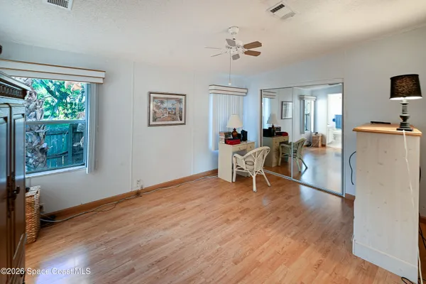 a bedroom with furniture and a wooden floor