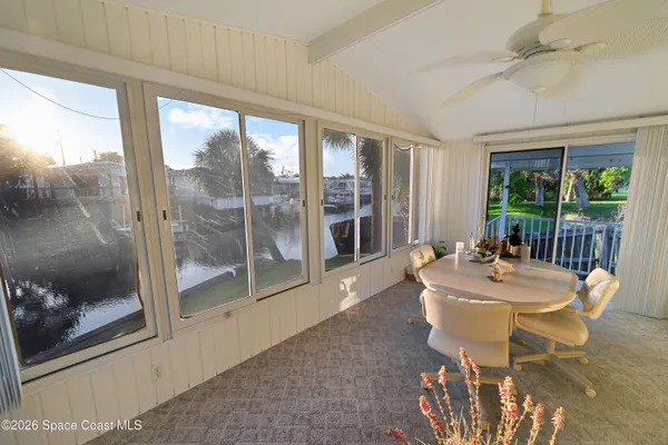 a view of a house with backyard and a tree