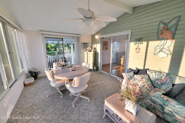 a view of a house with a small yard and wooden fence