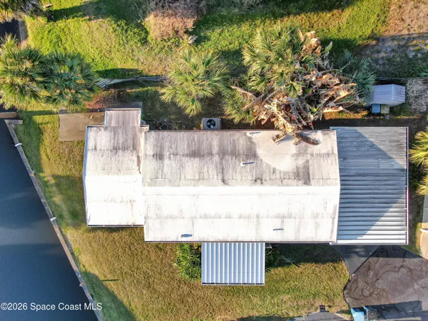 a kitchen with stainless steel appliances kitchen island granite countertop a refrigerator a sink a stove and a dining table with chairs