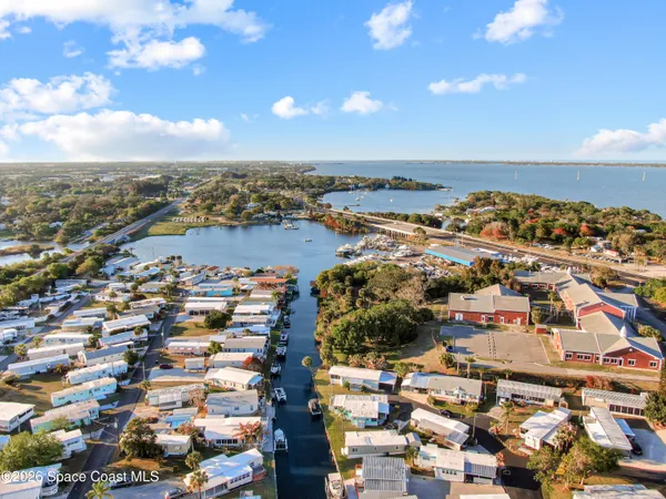 a view of a dining room with furniture and a potted plant