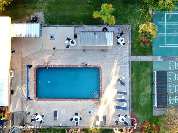 a backyard of a house with lots of green space and plants