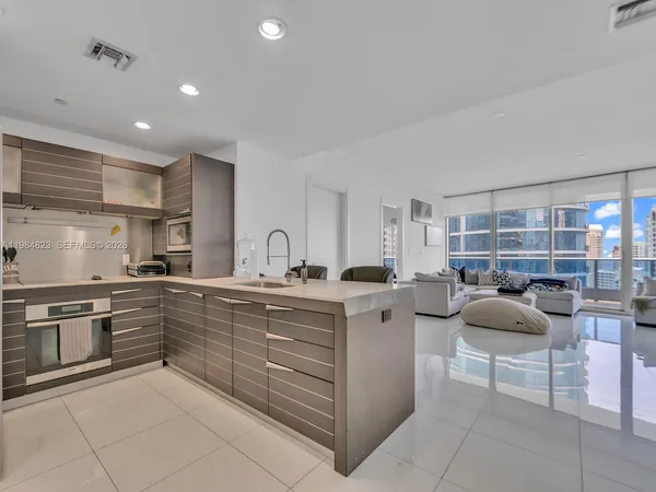 a kitchen with cabinets and chairs