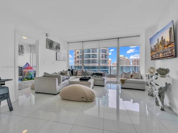 a living room with furniture and a large window