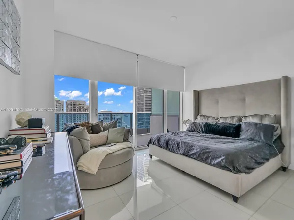 a bedroom with a bed window and couch