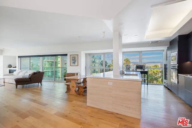 a living room with furniture and large windows