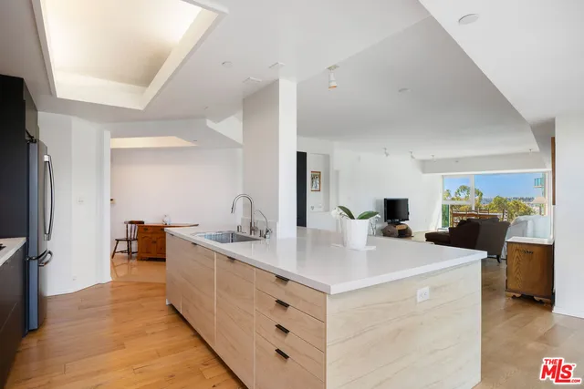 a view of living room with granite countertop furniture and a flat screen tv