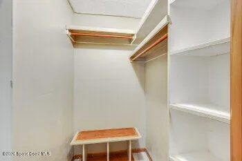 a view of room with a window and a ceiling fan