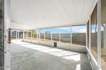 a spacious bedroom with a large window and walk in closet