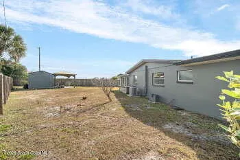 a view of a house with wooden fence