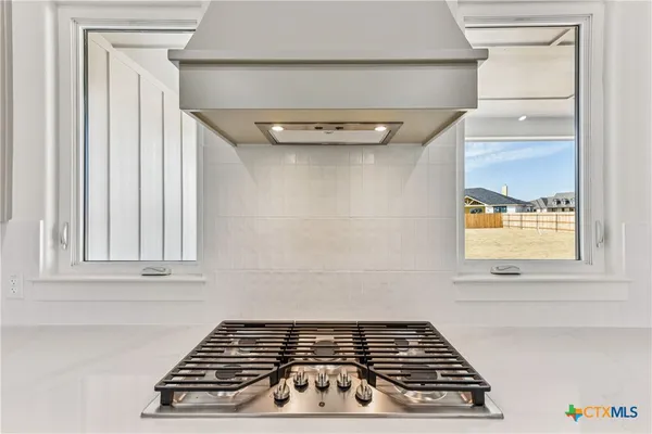 a close view of a stove a microwave and door