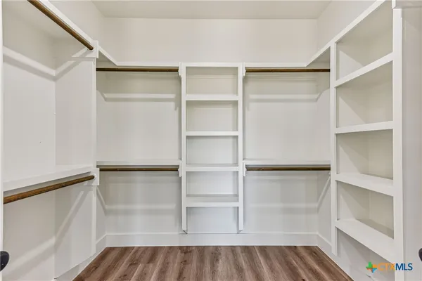 a walk in closet with empty racks