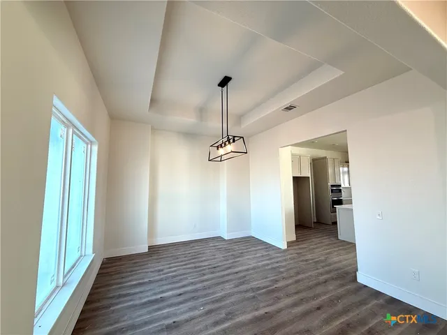 a view of a room with wooden floor table and closet
