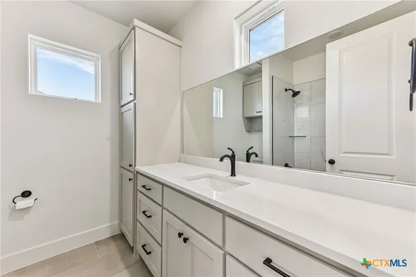 a bathroom with a sink and a mirror