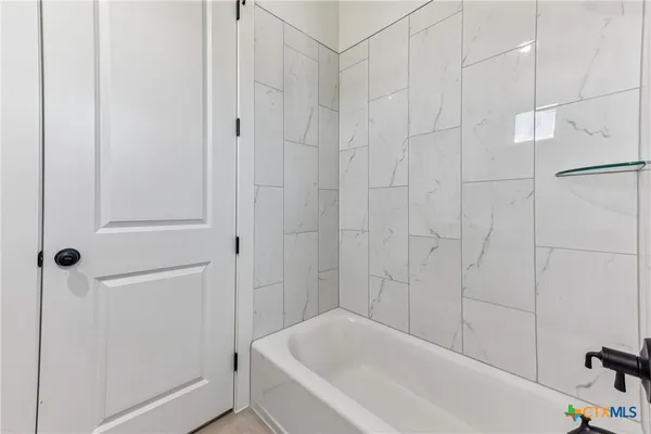 a white bath tub and shower