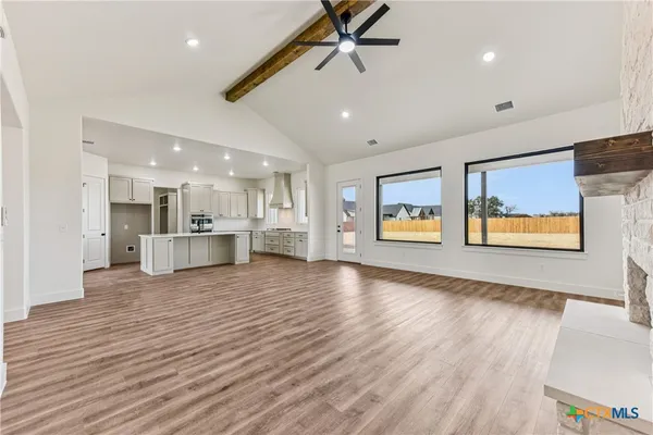 a view of a kitchen with furniture and wooden floor