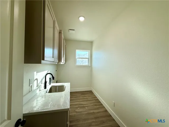 a kitchen with sink and cabinets