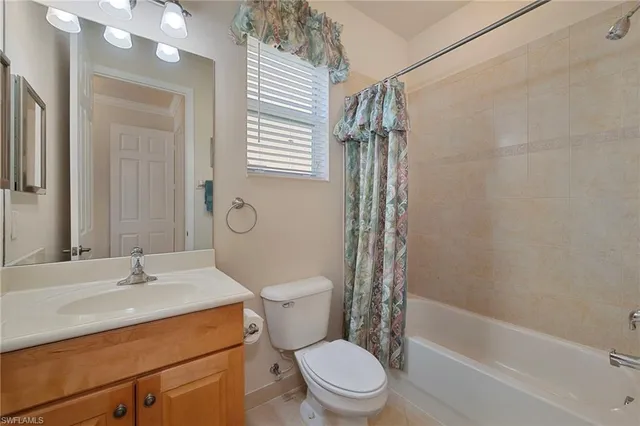 a bedroom with two beds and a flat tv screen on dresser