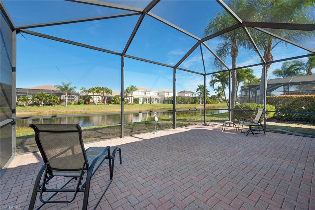 6529 Marbella Drive Naples, FL 34105 - Photo 15 of 29 a view of a patio with a table and chairs under an umbrella