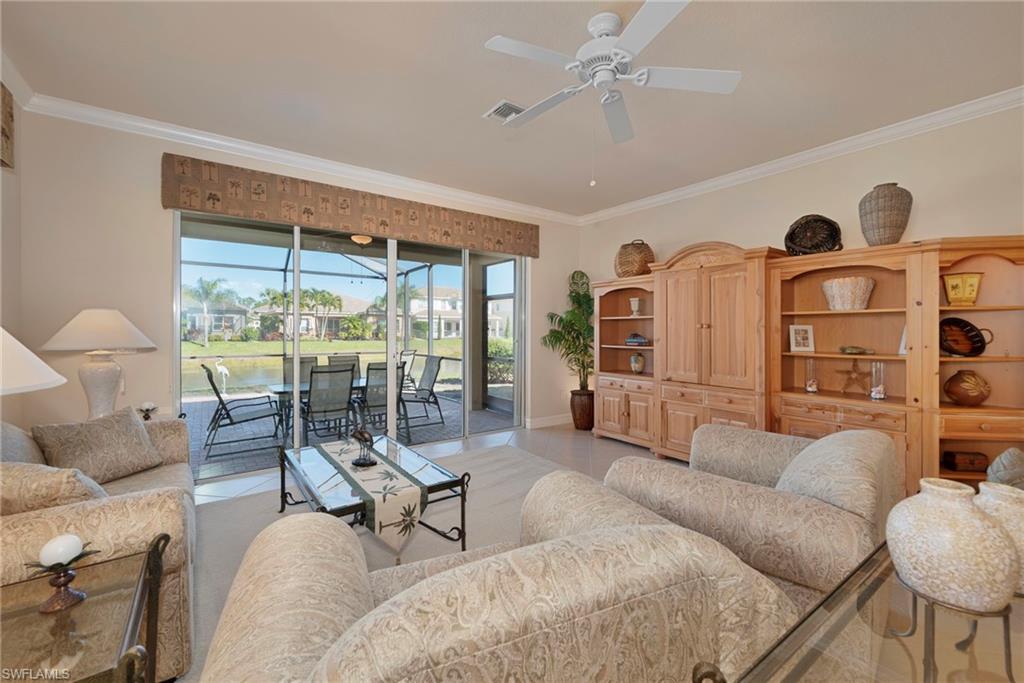 6529 Marbella Drive Naples, FL 34105 - Photo 2 of 29 a living room with furniture and a large window